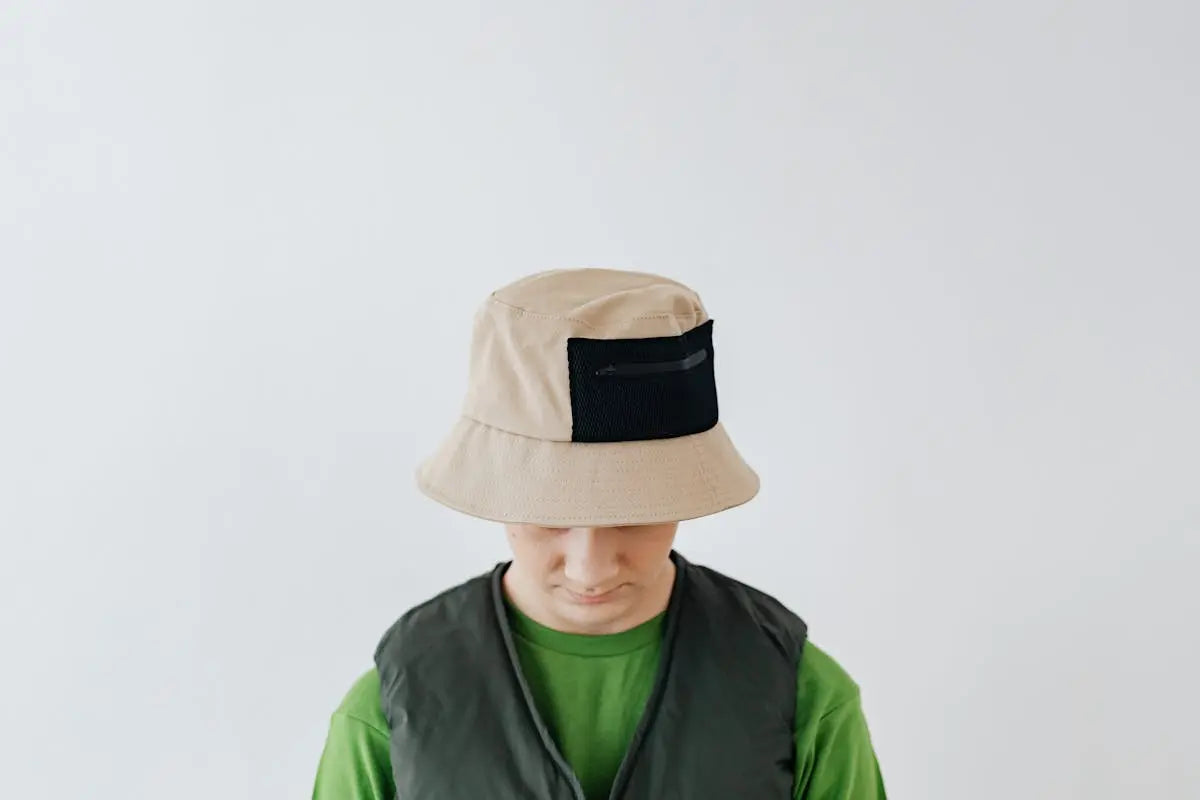 boy wearing bucket hat looking down